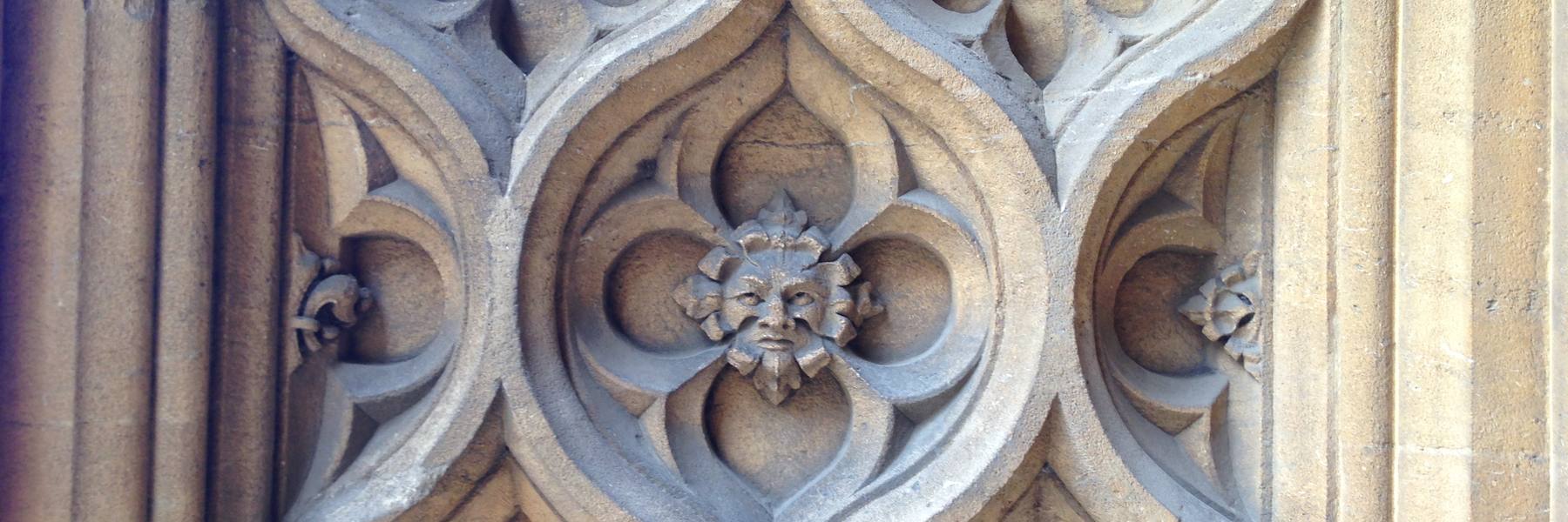 A carved gargoyle against cathedral stone